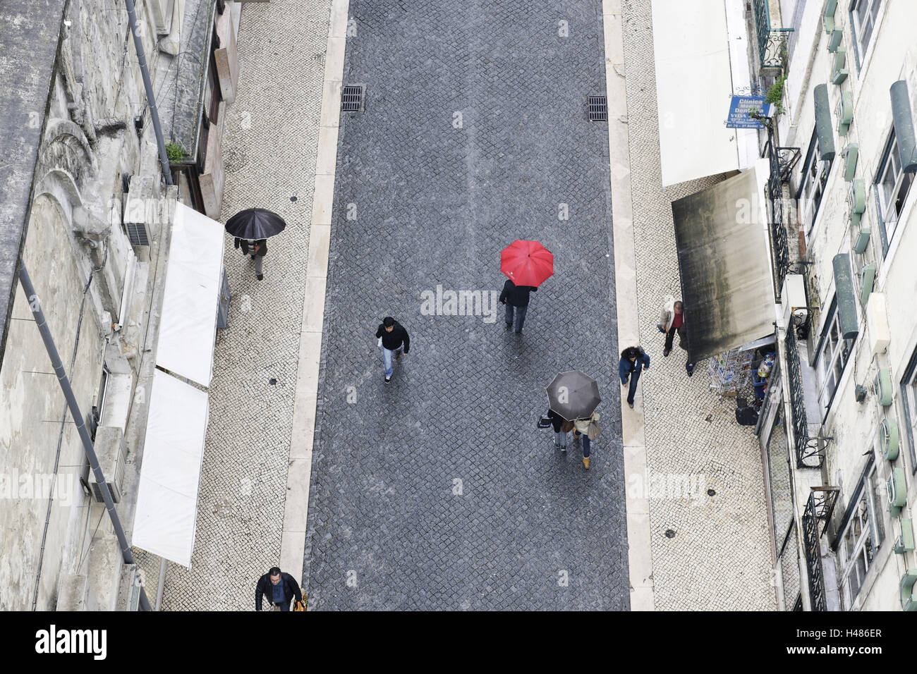 People with colourful umbrellas, vertical view from the Elevador de