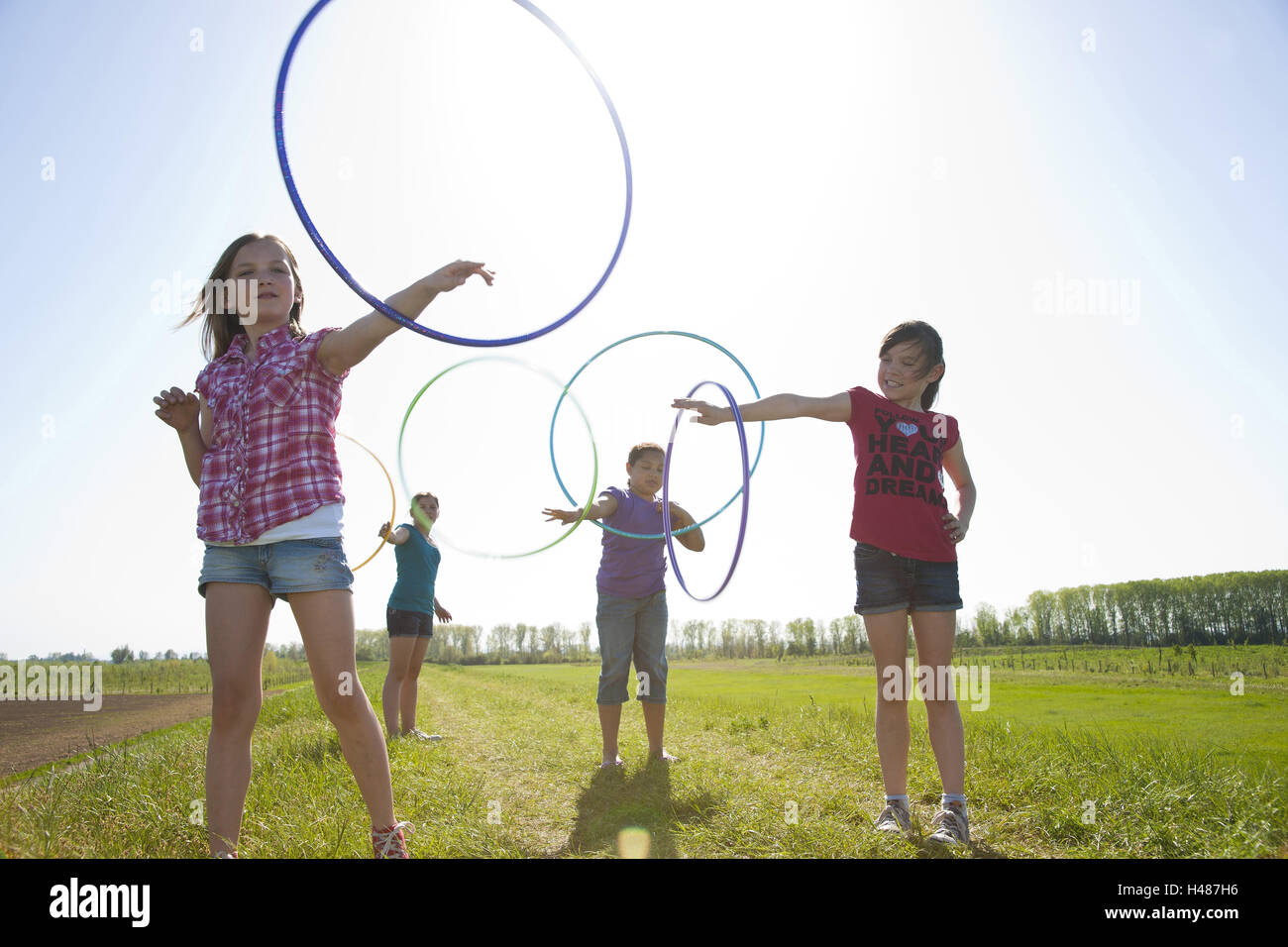 four girls with Hula-Hoop tyres, Stock Photo