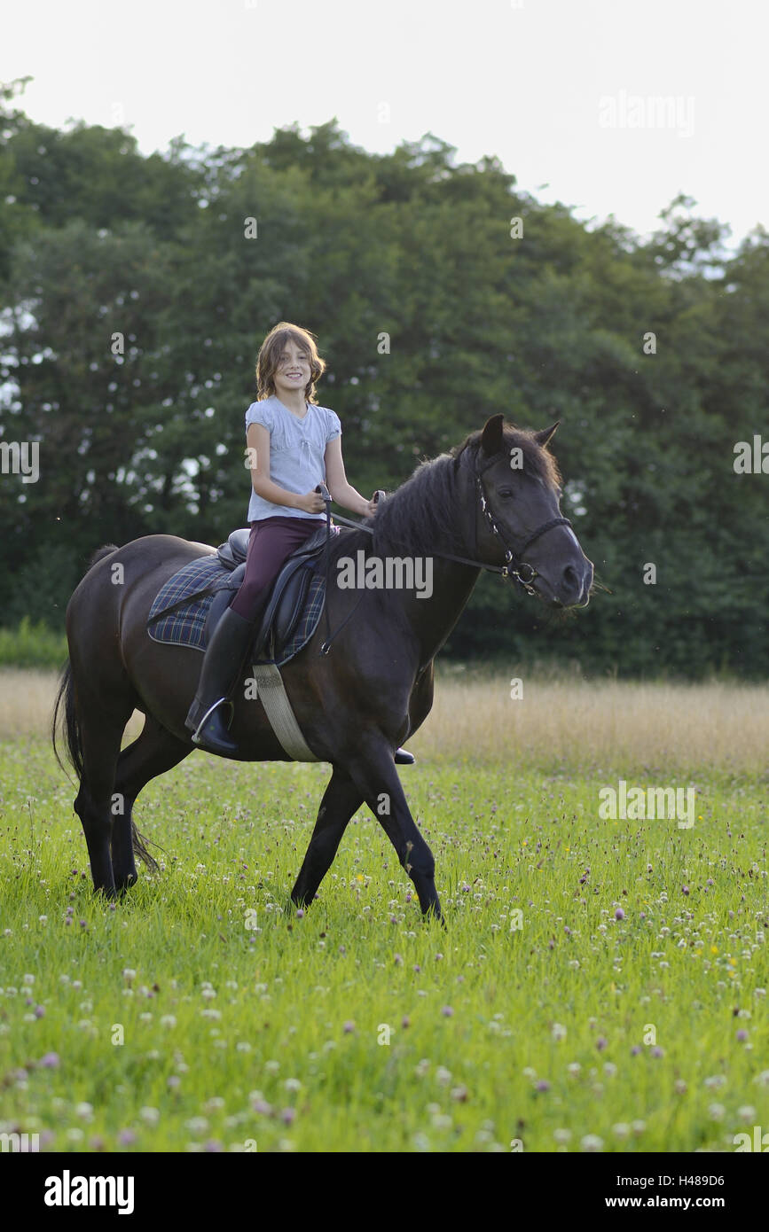 Girl, horse, meadow, riding, side view, looking at camera, landscape, Stock Photo