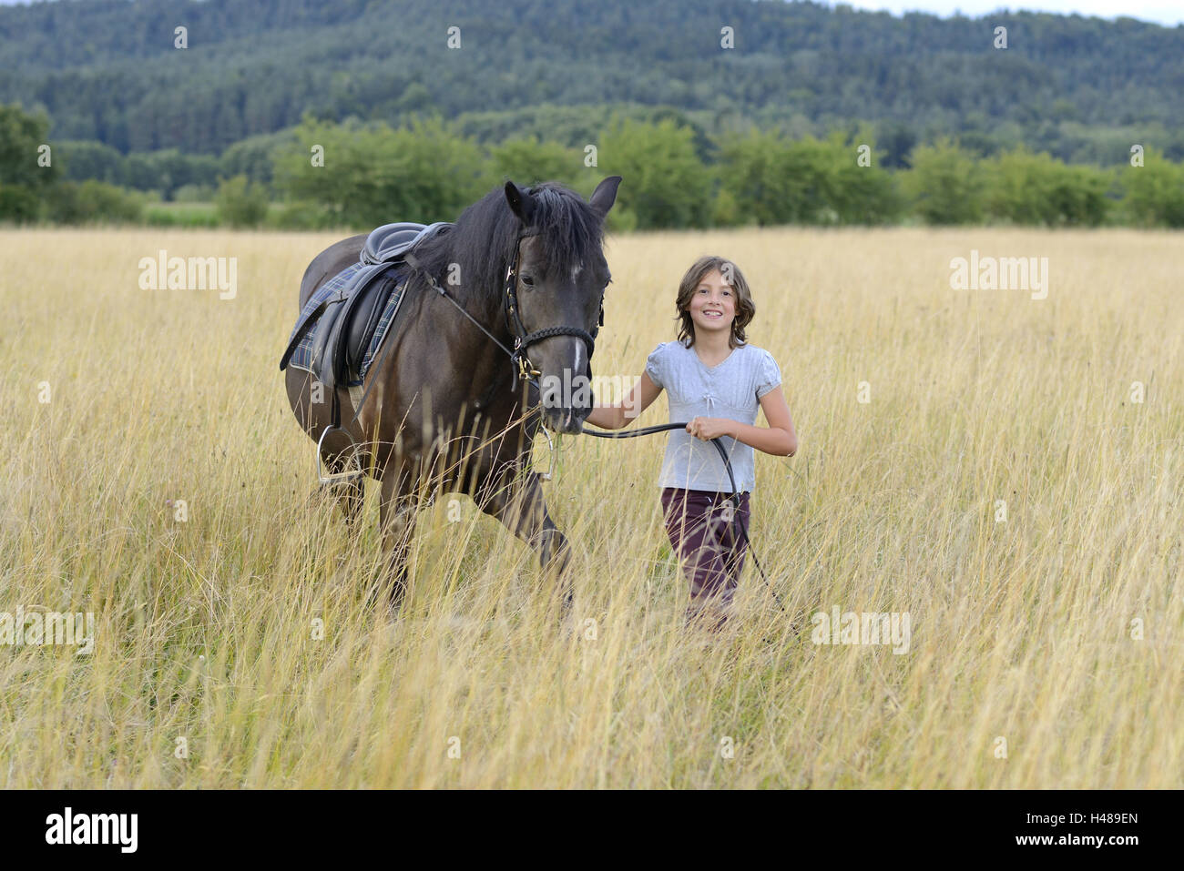 Girl, horse, meadow, looking at camera, landscape, Stock Photo