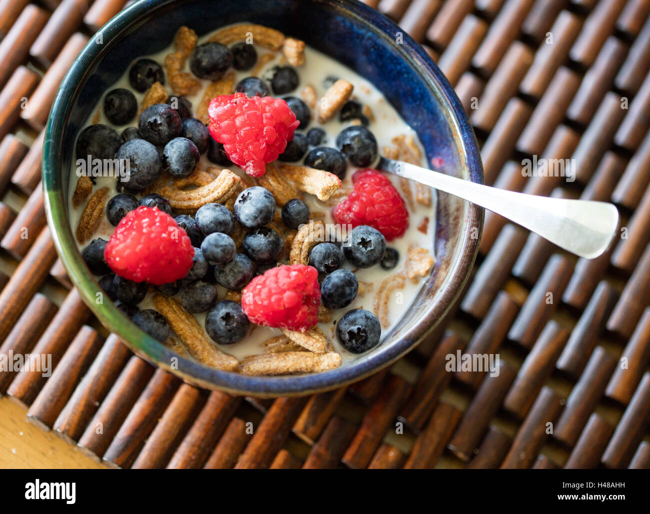 High fiber cereal with fresh blueberries and raspberries Stock Photo