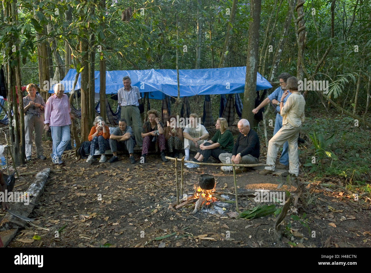 Brazil, Rio Negro, primeval forest, camp, hammocks, tourists, campfires, entertainment, South America, wood, primeval forest camp, sleeping places, tarpaulin, roofs, fireplace, person, tourist group, recreation, rest, vacation, adventure vacation, destination, tourism, Stock Photo