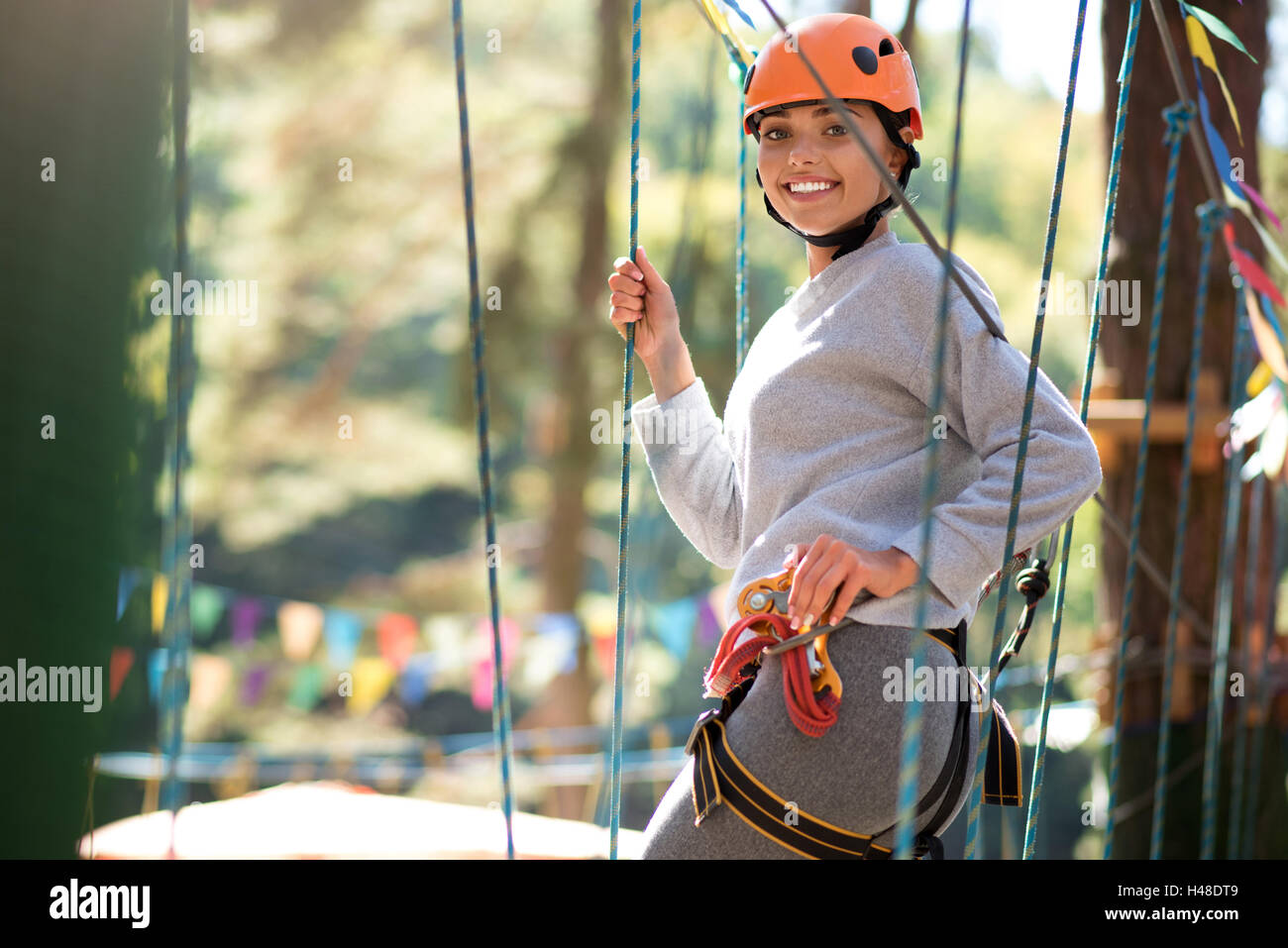 Cheerful positive woman having a great time in adventure park Stock Photo