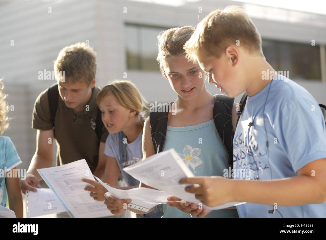 Pupils, reports, comparing, holding, showing, schoolyard, Stock Photo