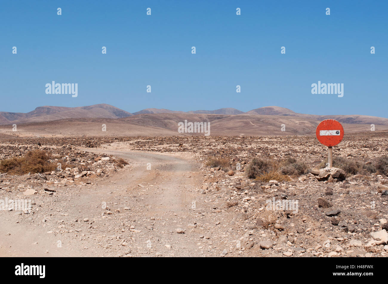 Fuerteventura, Canary Islands, North Africa, Spain: nature and landscapes, martian landscapes on a dirt road with an access ban Stock Photo