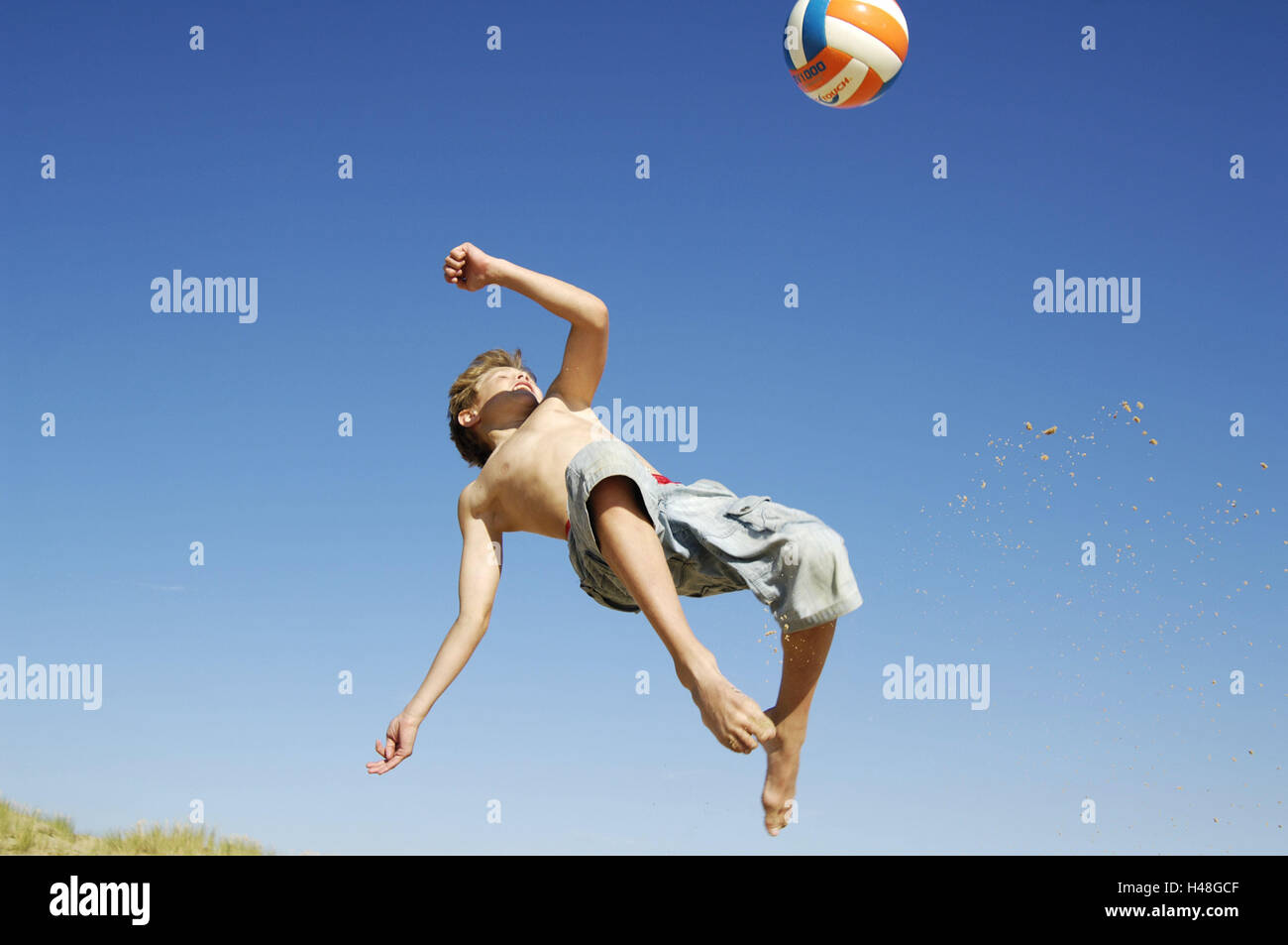 Boy, beach, to ball games, crack, summers, the sun, holidays, leisure time, vacation, child, fun, game, activity, motion, actively, hobby, football, overhead kick, jump, jump up, sport, ball, to football matches, Sand, Stock Photo