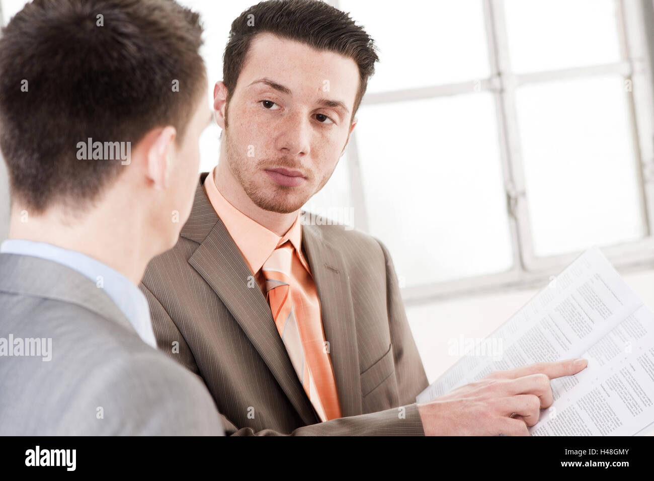 Two young entrepreneurs by a discussion Stock Photo Alamy