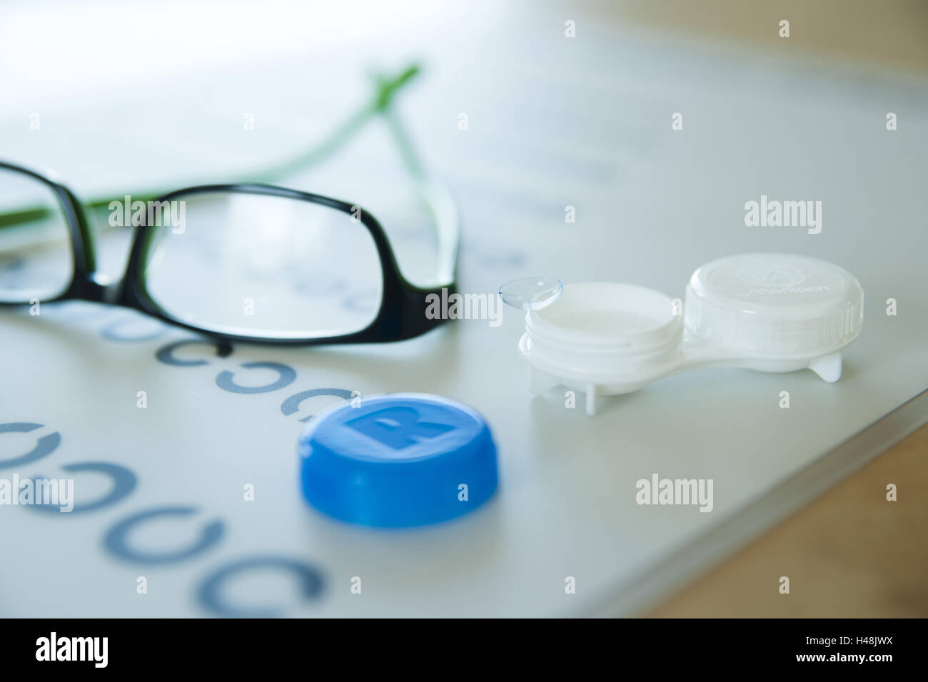 Contact lenses and glasses lie on a visual test, Stock Photo