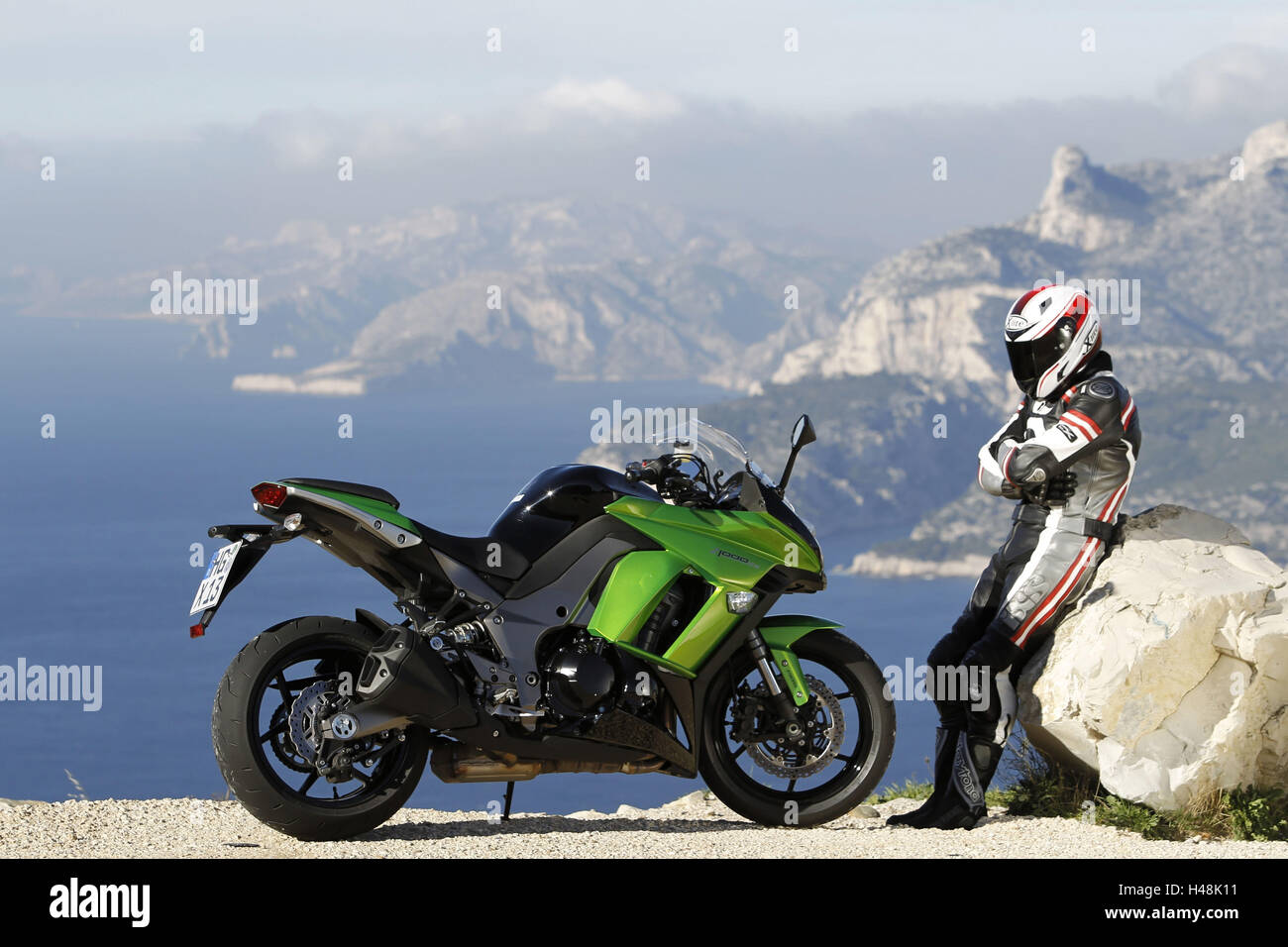 Motorcycle, Kawasaki Z 1000 SX, sports bike, coastal road, driver standing besides, Mediterranean landscape in the background, Stock Photo