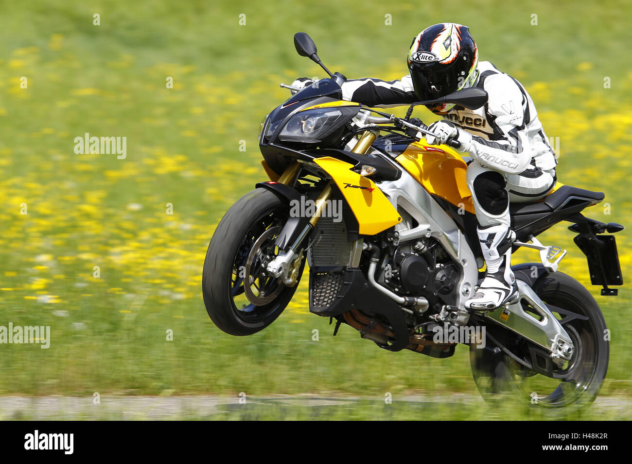Motorcyclist, motorcycle, Aprilia Tuono V4R, left page, yellow, Wheelie