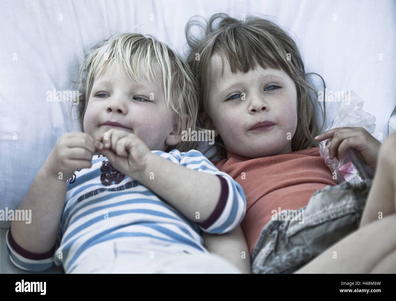 Two children lying on blanket Stock Photo Alamy