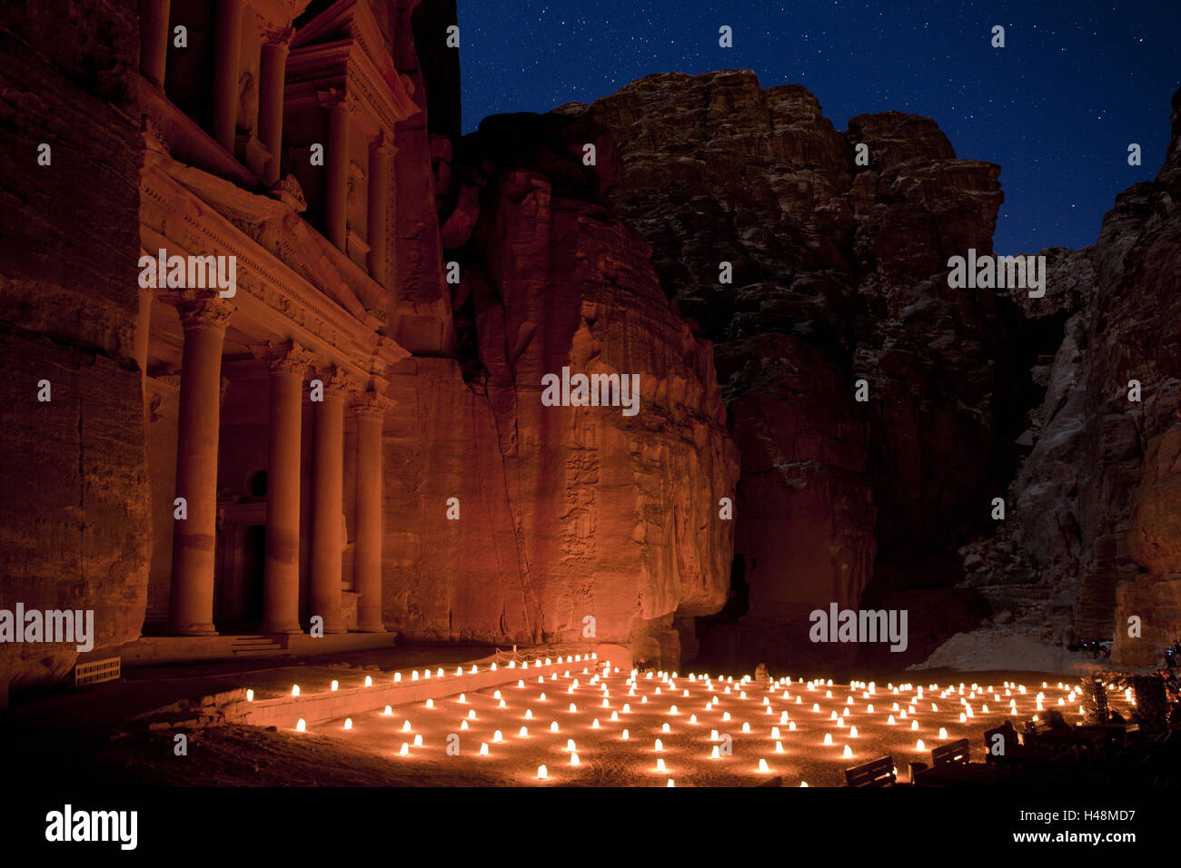 Jordan, historical archaeological city Petra, the Siq, Entrance to the rock town, view at Khazne al-Firaun, treasure house of the Pharaoh, by night, lights, illuminated, Stock Photo