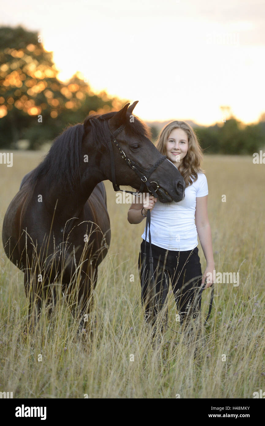 Girls, horse, meadow, stand, view camera, scenery, Stock Photo