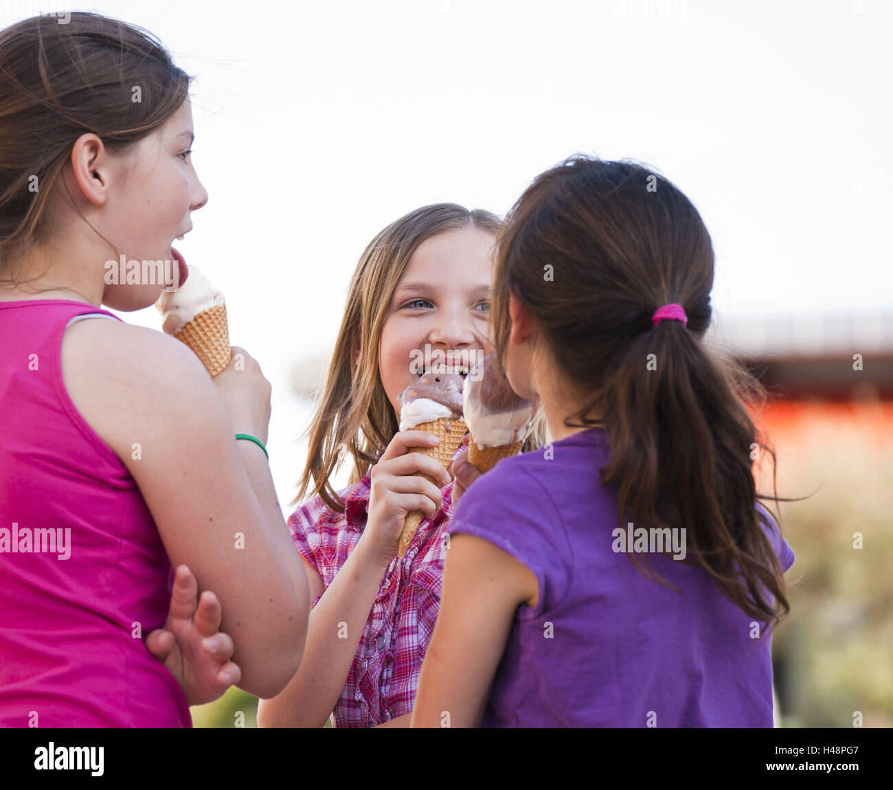 three friends eating ice cream Stock Photo Alamy