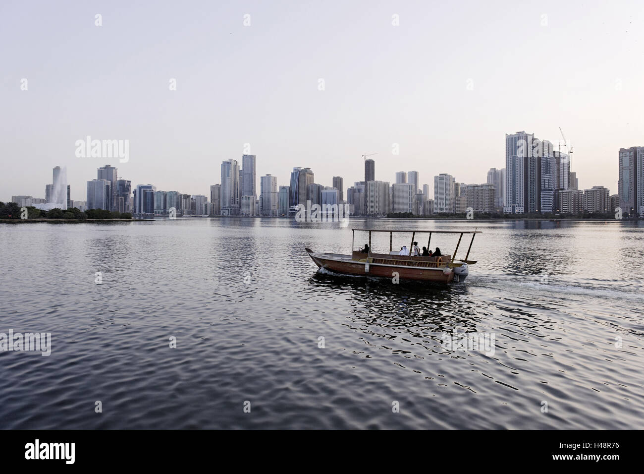 Local on small boot, Sharjah Creek, skyline, Corniche Street, emirate Sharjah, United Arab Emirates, Arabian peninsula, the Middle East, Asia, Stock Photo