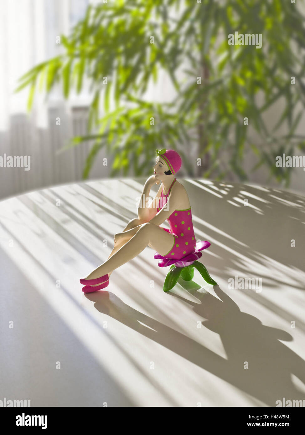 Ceramics figure, decoration, woman, seated, figure, ceramics, table, flat, green plant, light, brightly, sunlight, table appointments, indoor plant, shade, beams light, sunlight, icon, design, cosiness, relaxating, rest, thought, recreation, rest, vacation, Stock Photo