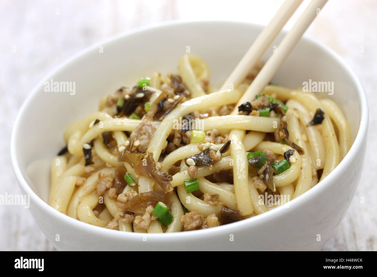 dan dan noodles, chinese sichuan cuisine, mixing the noodles Stock Photo