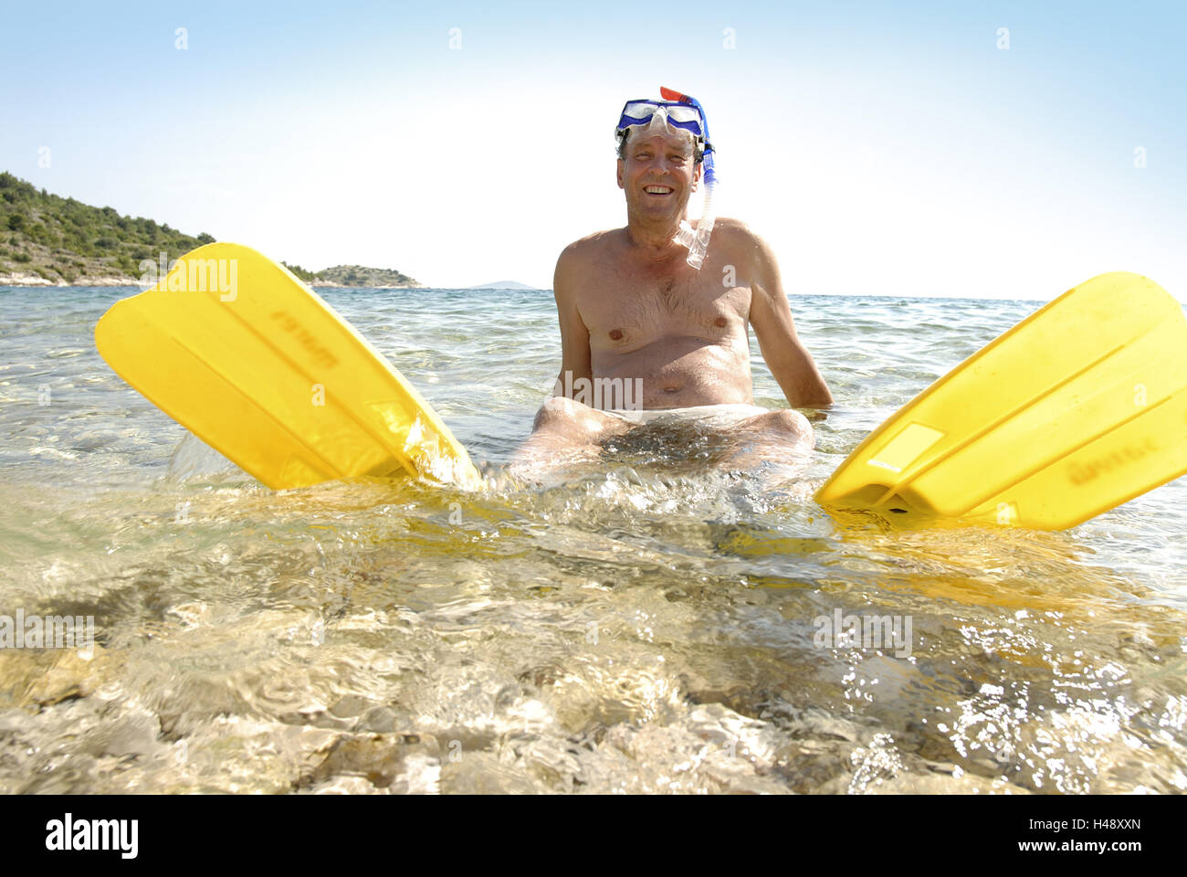 Man, snorkel equipment, swimming fins, sea, sit, Stock Photo