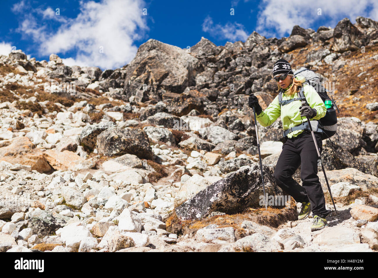 Woman hiker trekking with big backpack in Himalaya Mountains on Rocky ...