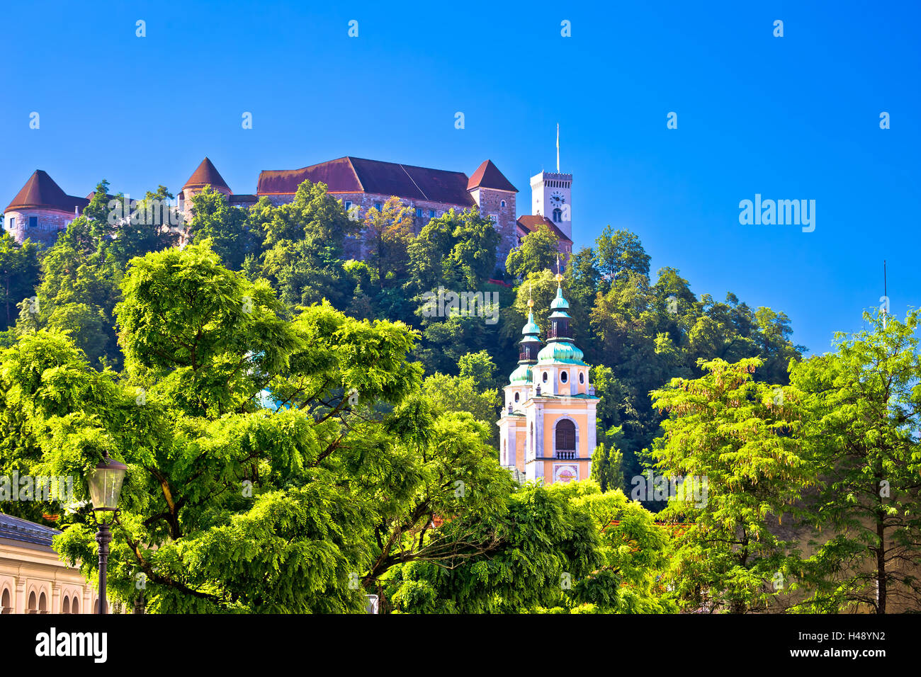 Ljubljana towers and fort on green hill, capital of Slovenia Stock Photo