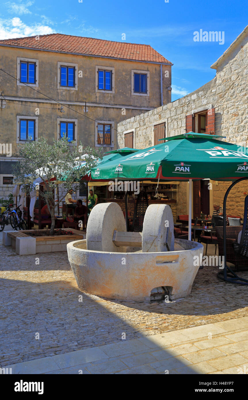 Millstones outside a bar in Vrboska, Hvar Island, Croatia, Dalmatia, Dalmatian Coast, Europe. Stock Photo