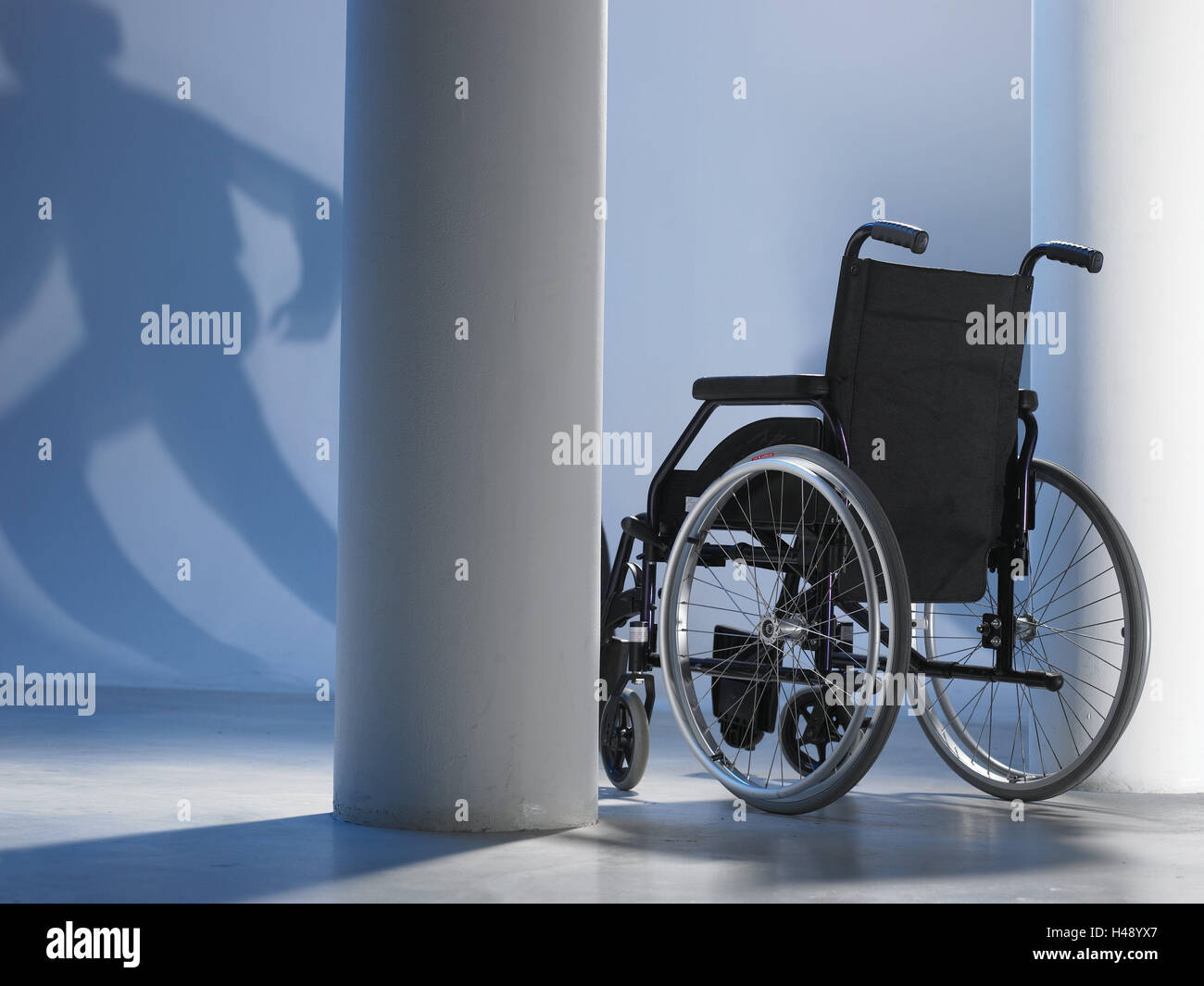 Invalid's wheel chair, shade, person, run away, go walk, hall, pillar, person, sunshine, shade, exited, impediment, convalescense, accident, blank, escape, out, flight, health, helplessness, security, Stock Photo