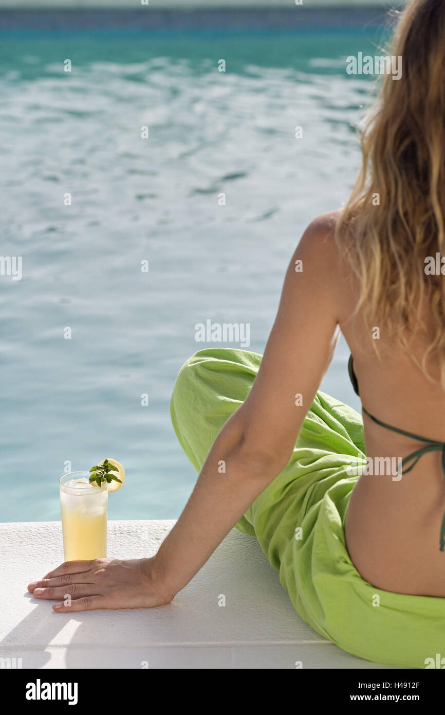 Woman, bikini, Pareo, sitting, pool edge, cocktail, back view, model released, Stock Photo