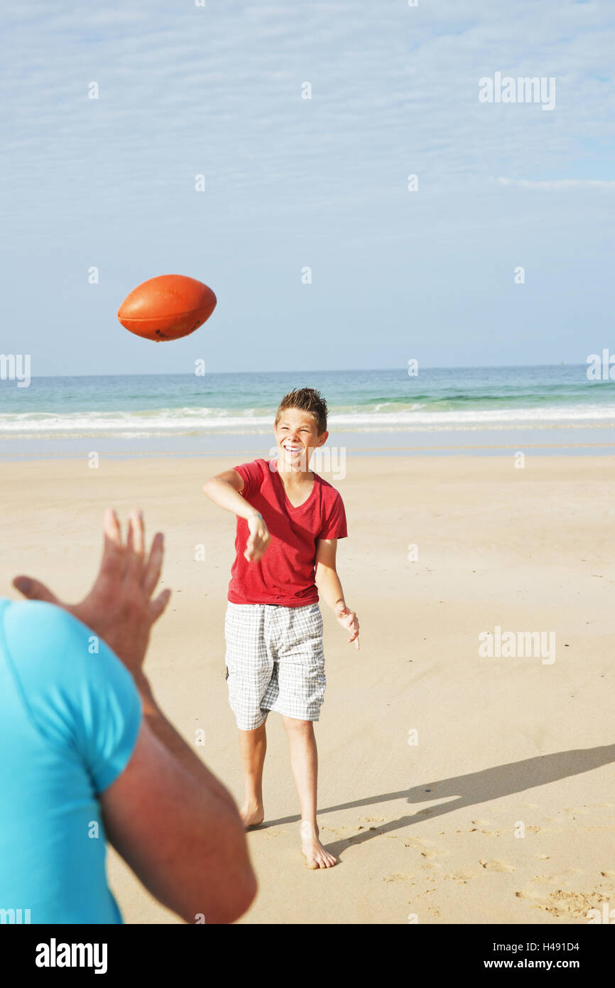Father and son on the beach, ball play, Stock Photo