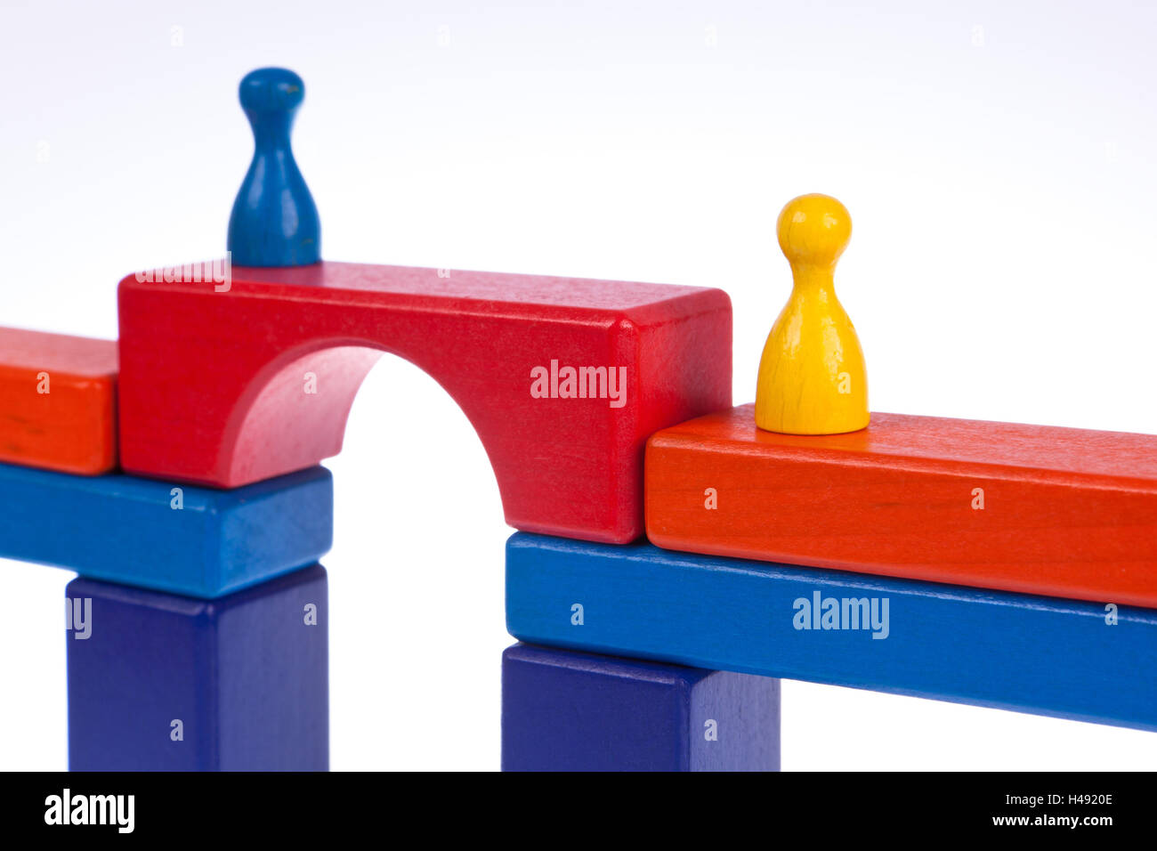 Gaming pieces and building blocks symbolising breaking down barriers ...