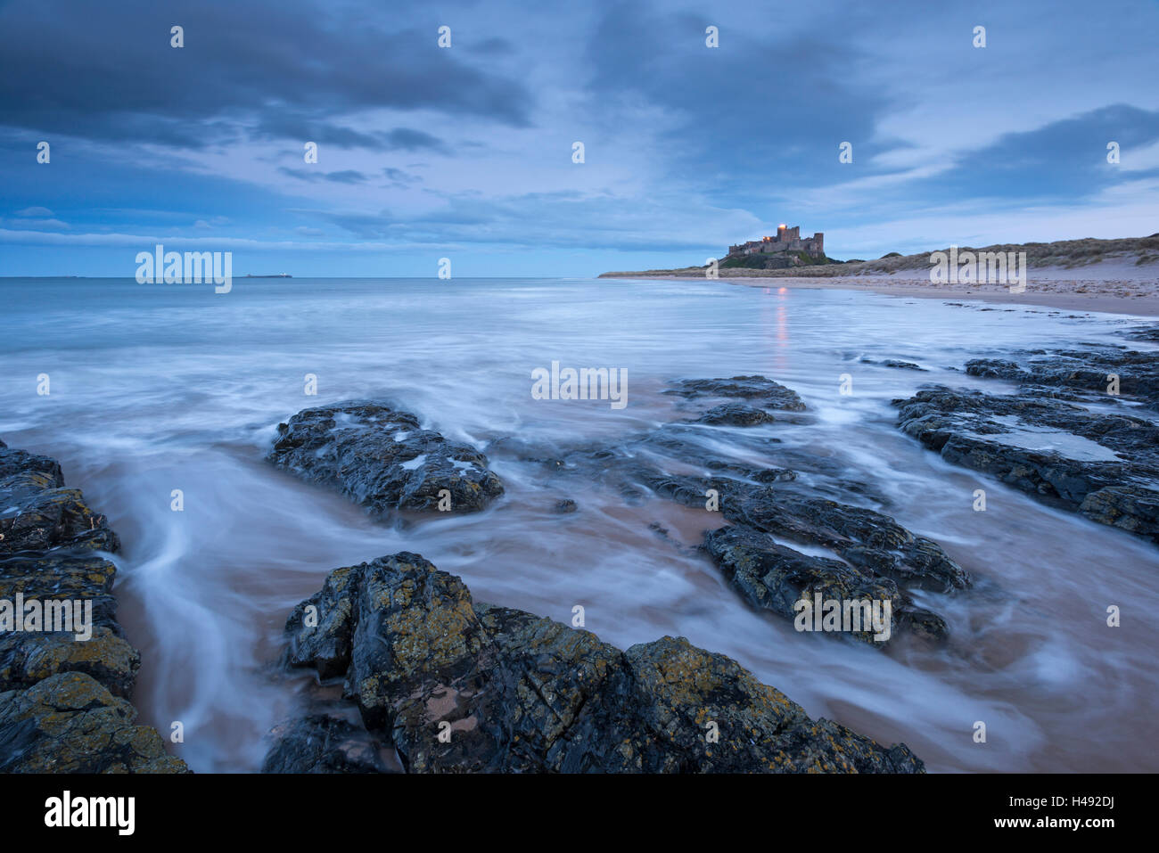 Stormy evening on the beach near Bamburgh Castle, Northumberland, England. Winter (March) 2014. Stock Photo