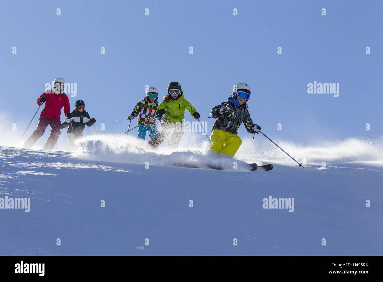 five skiers, children and adults on the runway, Stock Photo
