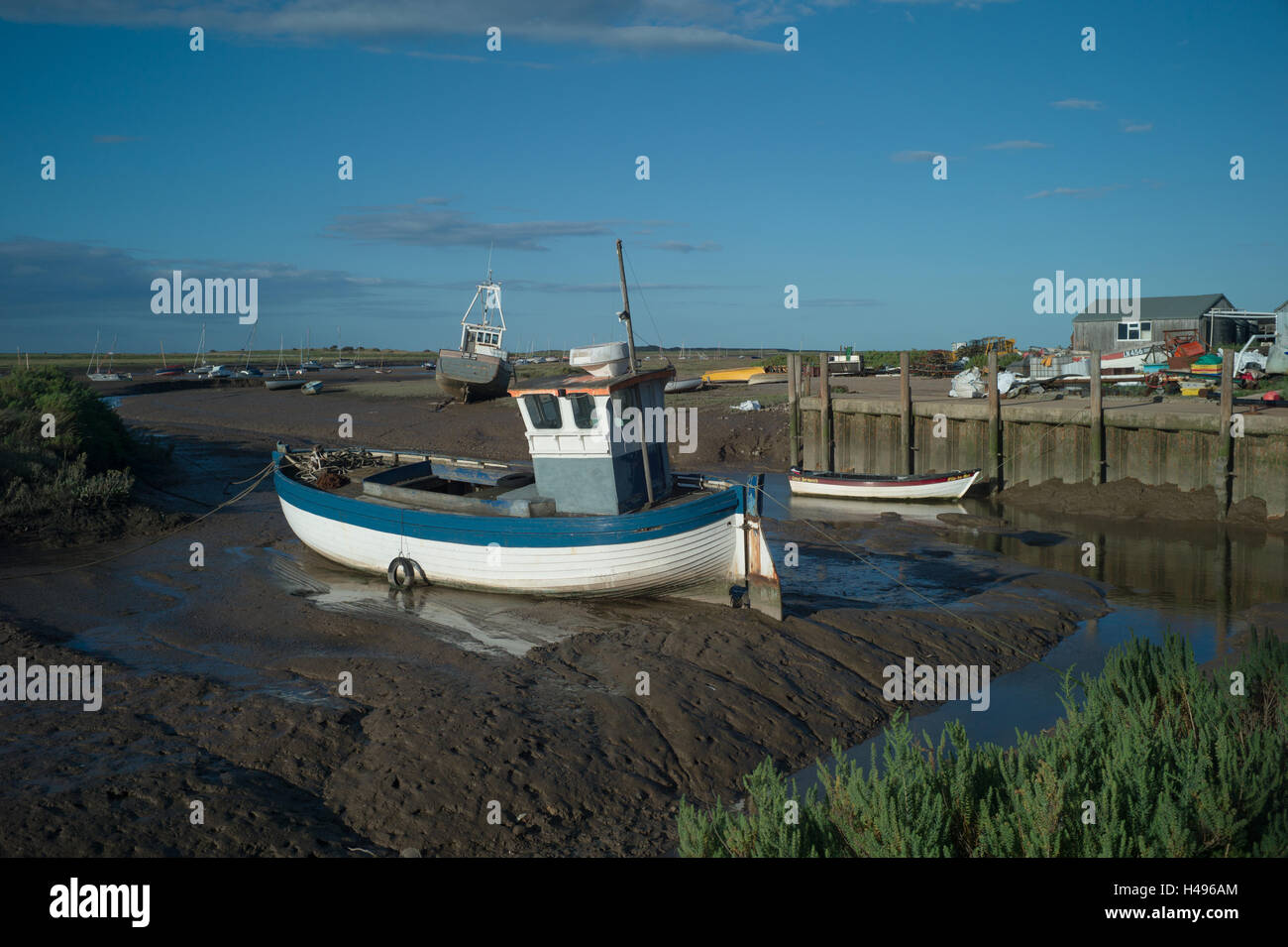 Brancaster Staithe on the North Norfolk Coast, England  boats on mudflats at Low tide. Stock Photo