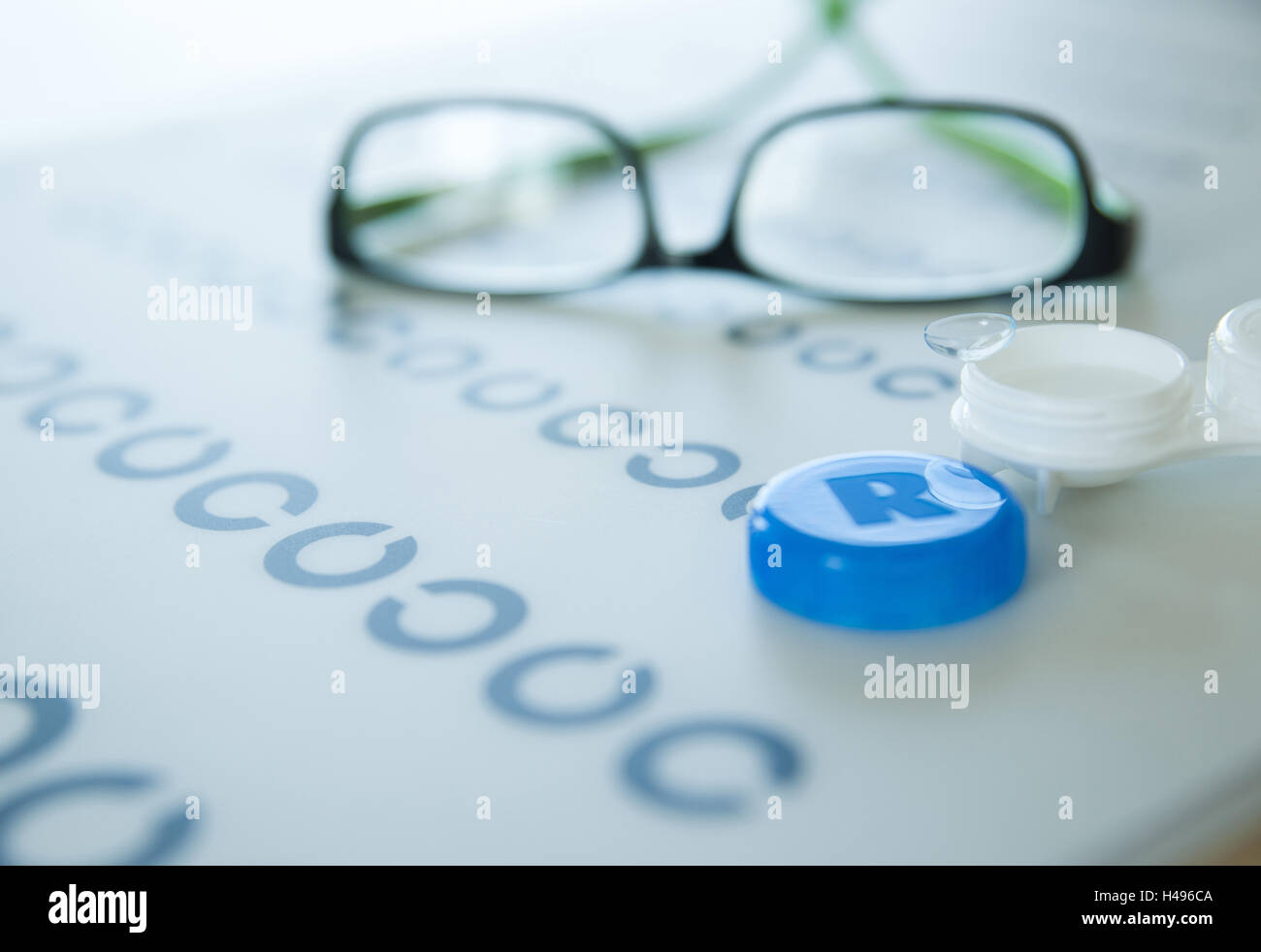 Contact lenses and glasses lying on a visual test, Stock Photo