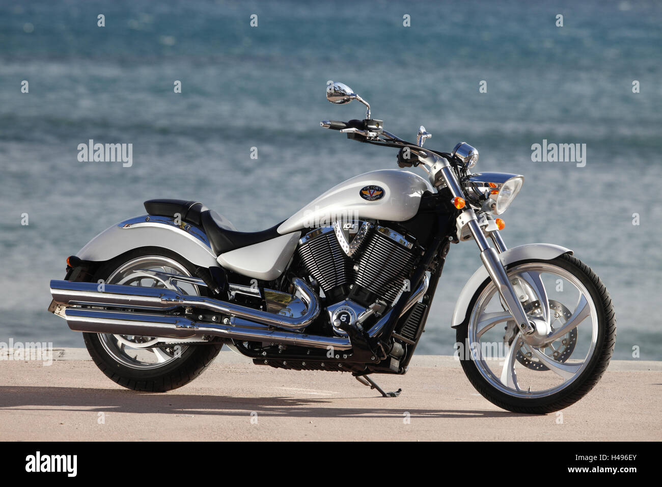 Motorcycle, Cruiser, Victory, white metallic, sea in the background, page standard on the right, Stock Photo