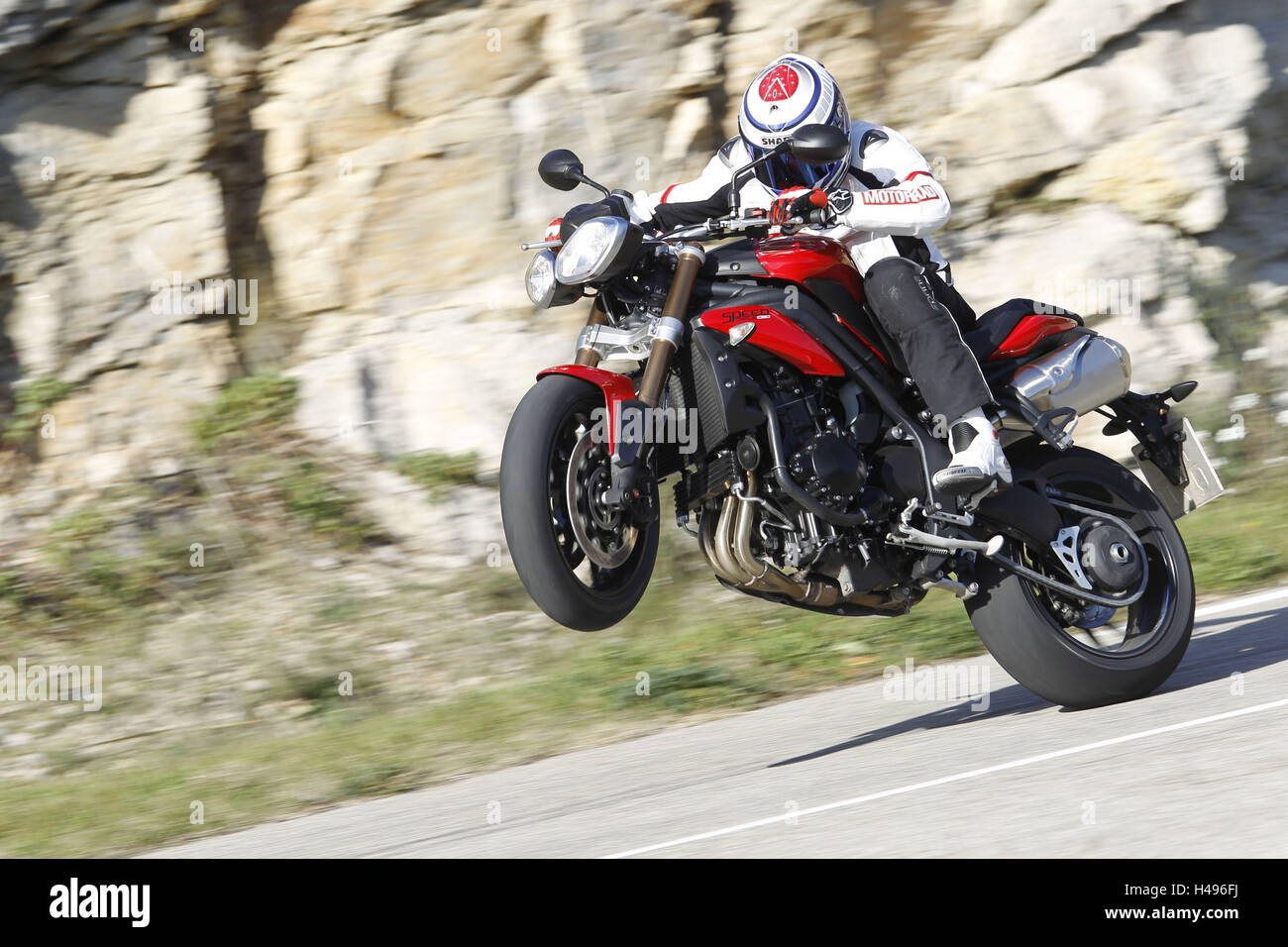 Motorcyclist, triumph, Wheelie, country road, moving, cliff face, the South France, Stock Photo