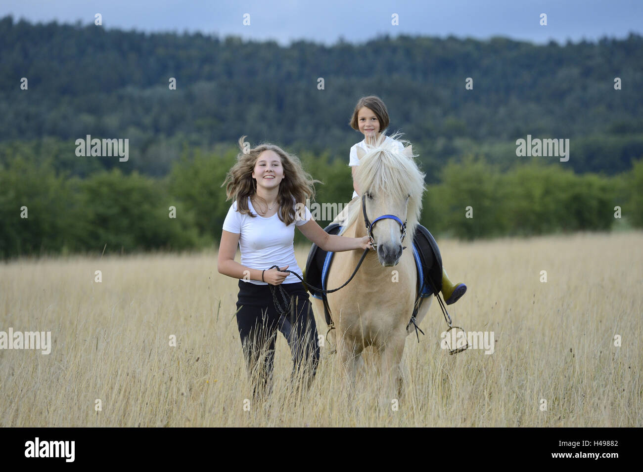 Girls, horse, meadow, view camera, scenery Stock Photo - Alamy