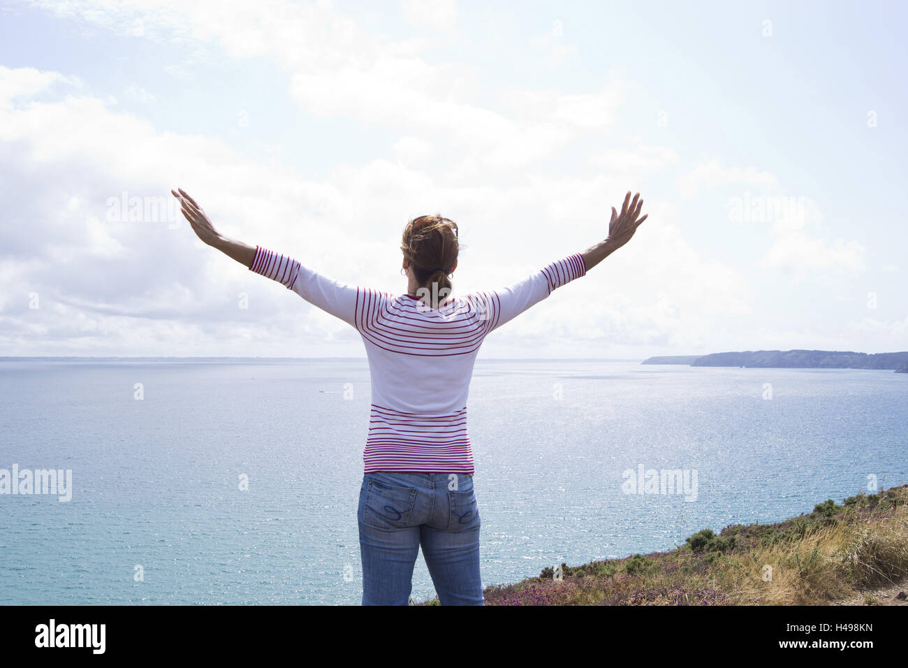Woman, coast, view of the sea, arms spread, back view, Stock Photo