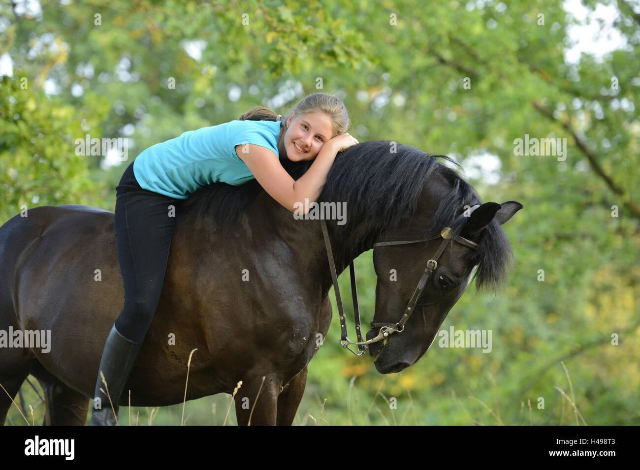 Teenage girl, horse, Arabian Haflinger, horseback, lying, looking at camera, Stock Photo