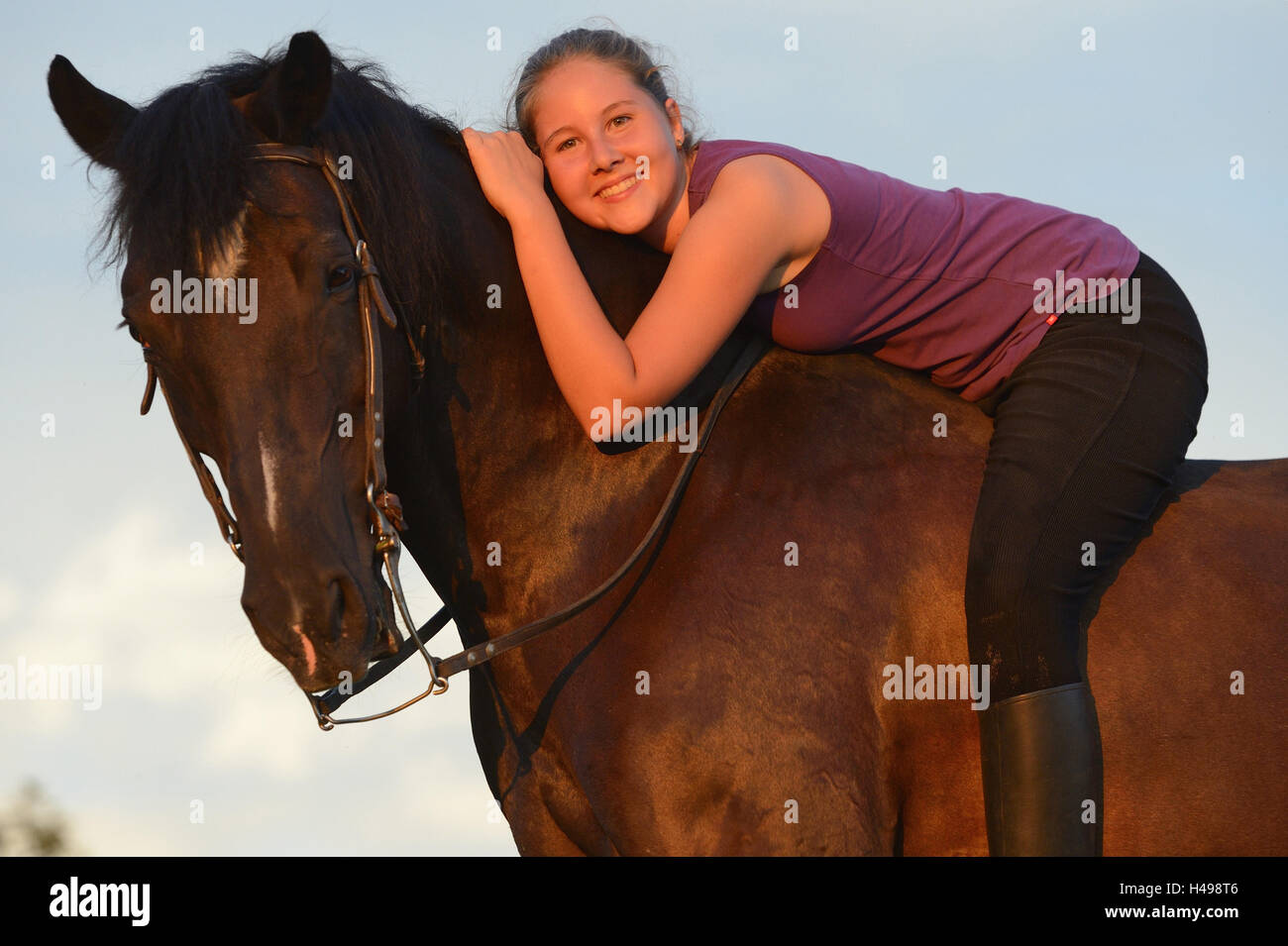 Teenage girl, horse, Arabo-Haflinger, back, lie, view camera, Stock Photo