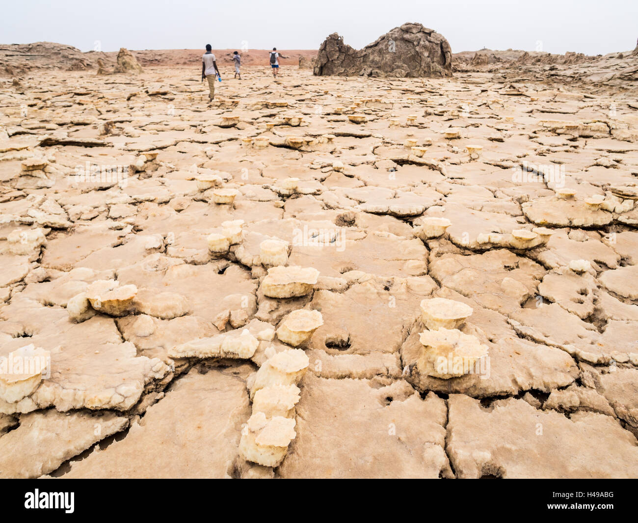 People Walk Across Mineral Soil Formations Around Sulfur Lake Dallol