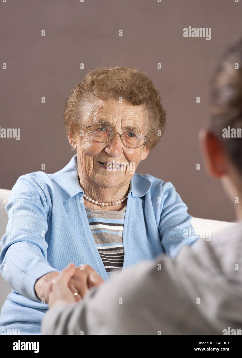 Granddaughter holds to her grandmother the hands, Stock Photo