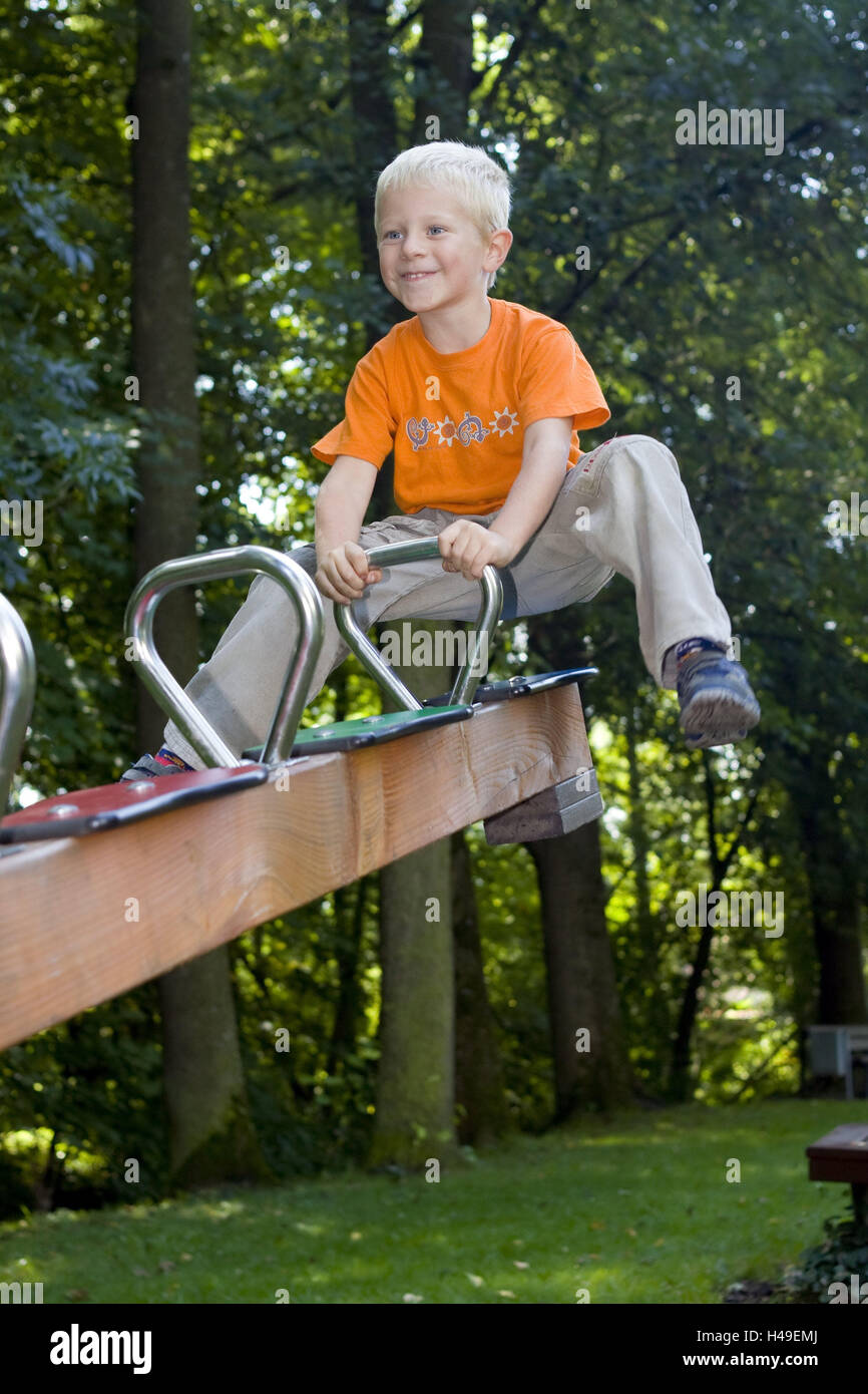 Playground, boy, smile, play seesaw, summer, garden, person, child, blond, leather, swing, crack, seesaw, joy, amusement, fun, happy, lighthearted, cheerfully, sit, motion, leisure time, childhood, whole body, trees, outside, Stock Photo