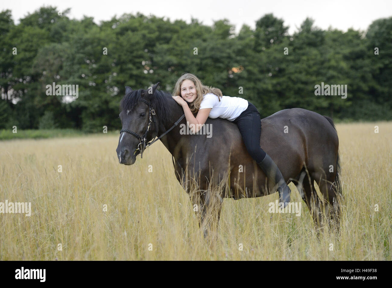 Girls, horse, back, lie, view camera, scenery, Stock Photo