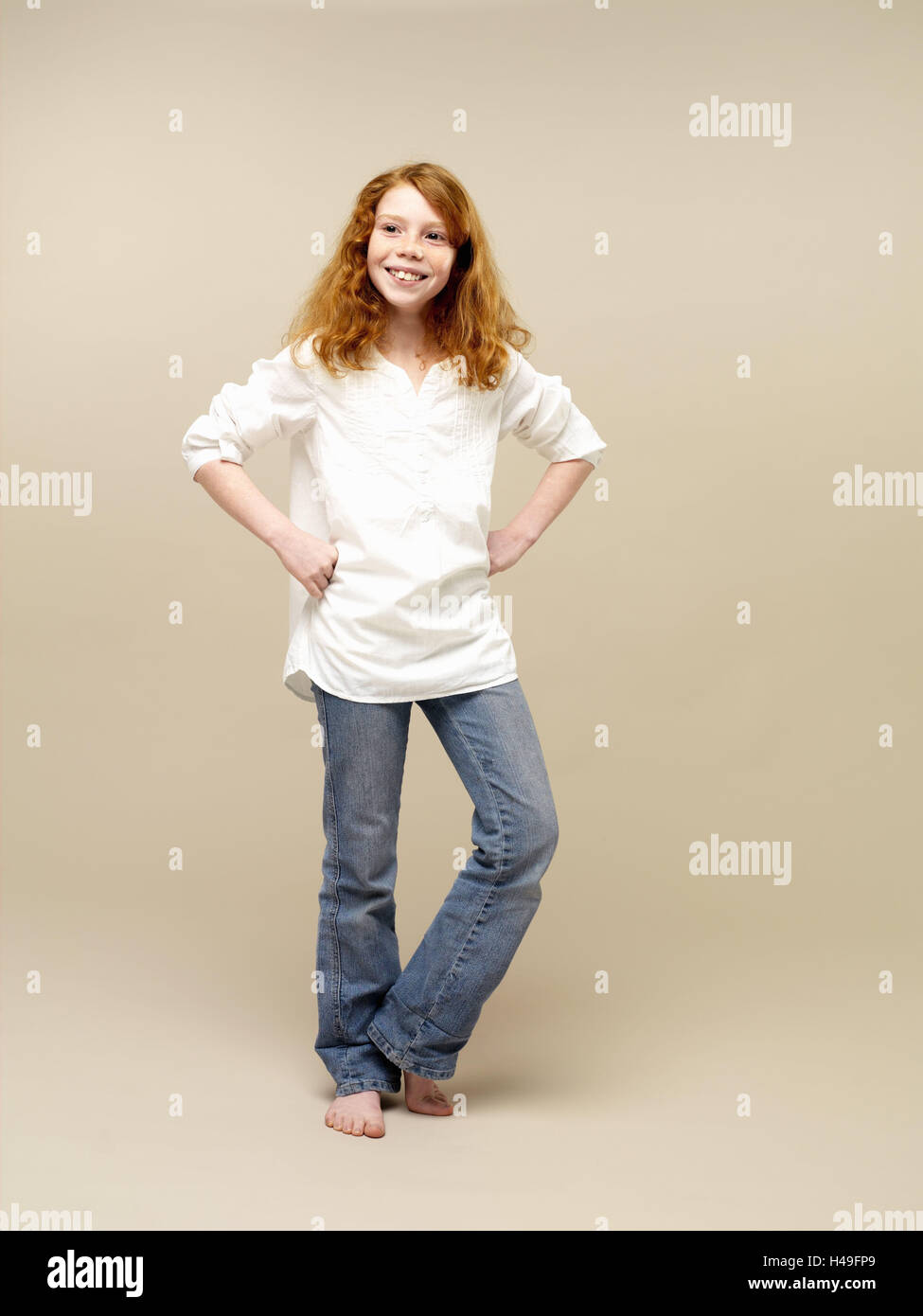 Girls, red-haired, self-confidently, gesture, hands hips, child, long-haired, jeans, blouse, shirt, leisurewear, careless, barefoot, stand, smile, add support contently, happy, mischievously, hands, hips, young persons, youth, childhood, side glance, whole body, studio, Stock Photo