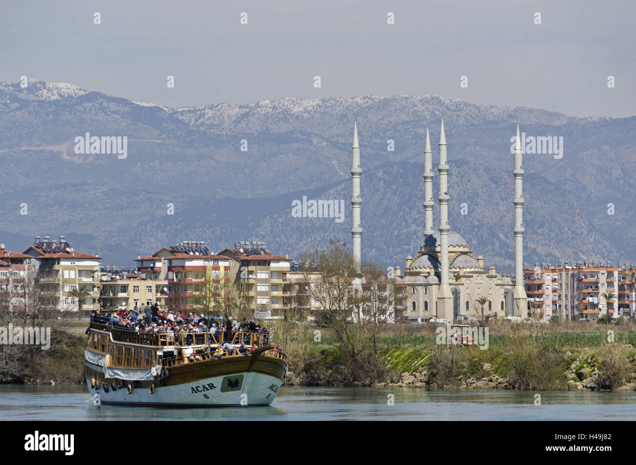 Turkey, south coast, province of Antalya, Manavgat, river, excursion steamer, tourist, tourists, mosque, Manavgat river, steamboat, holiday ships, ships, people, river scenery, tourism, ship excursion, excursion, minarets, towers, houses, buildings, mount Stock Photo