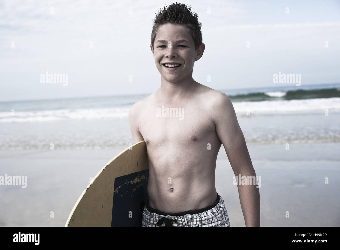 Boy with Skimboard on the beach Stock Photo Alamy