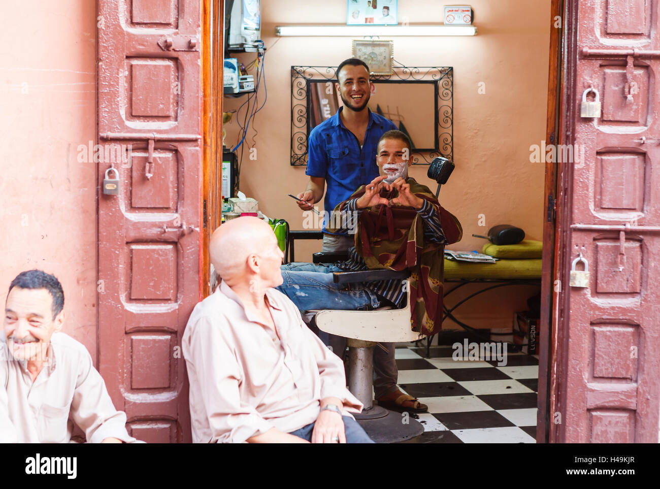 Friendly people in barber shop on the streets of Marrakesh, Morocco Stock Photo