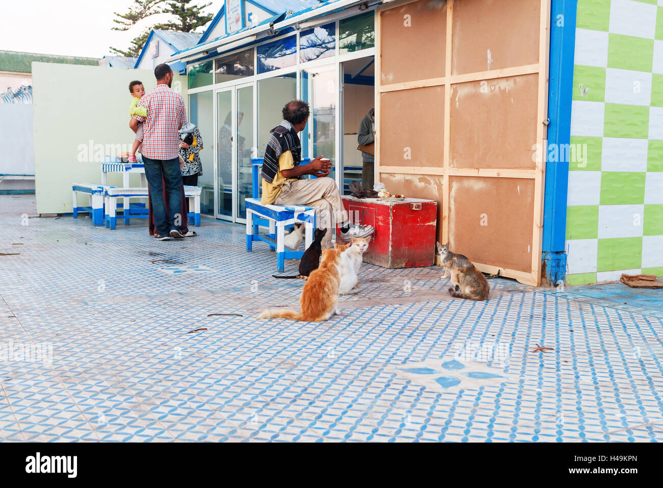 Local fish bar near the port in Essaouira, where everybody can fry just bought fish. Stock Photo