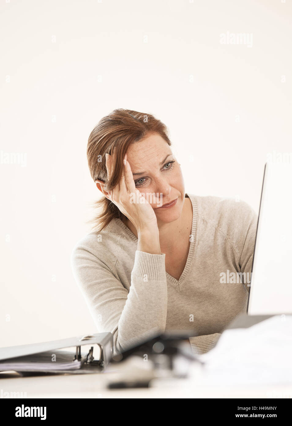 Woman sits frustrated before the computer, Stock Photo