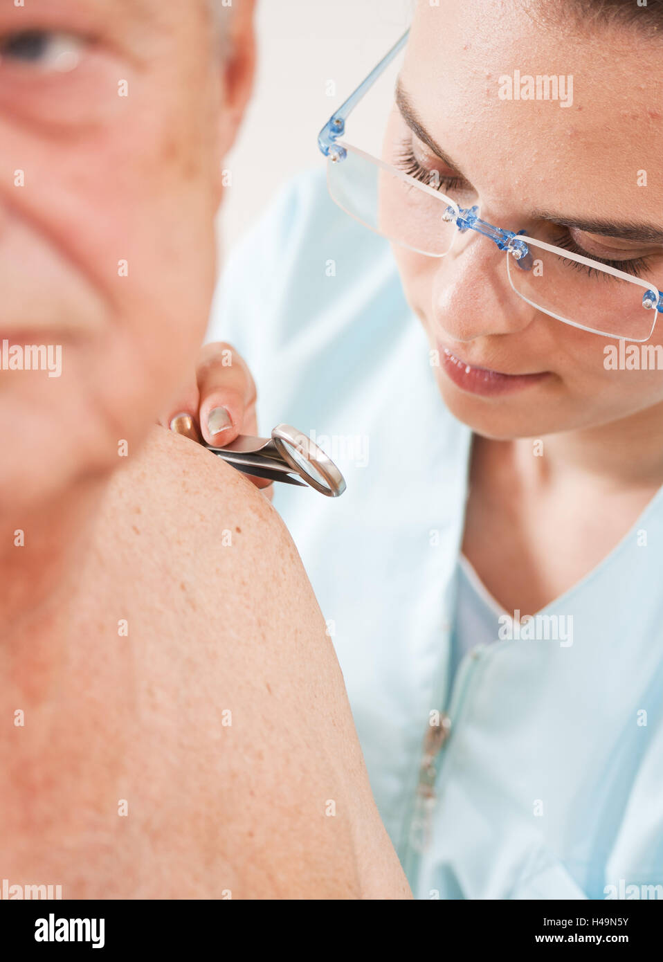 Boss is examined by young dermatologist, Stock Photo
